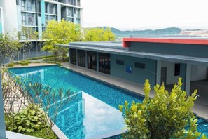 A swimming pool with a modern building in the background.