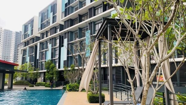 A modern building with balconies, a swimming pool, and a covered seating area. - CoreSoho Suite by BKAstaycation KotaWarisan Sepang KLIA Airport, Free Wifi (Sepang)