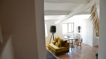 A cozy living room with a sofa, a coffee table, and a floor lamp.
