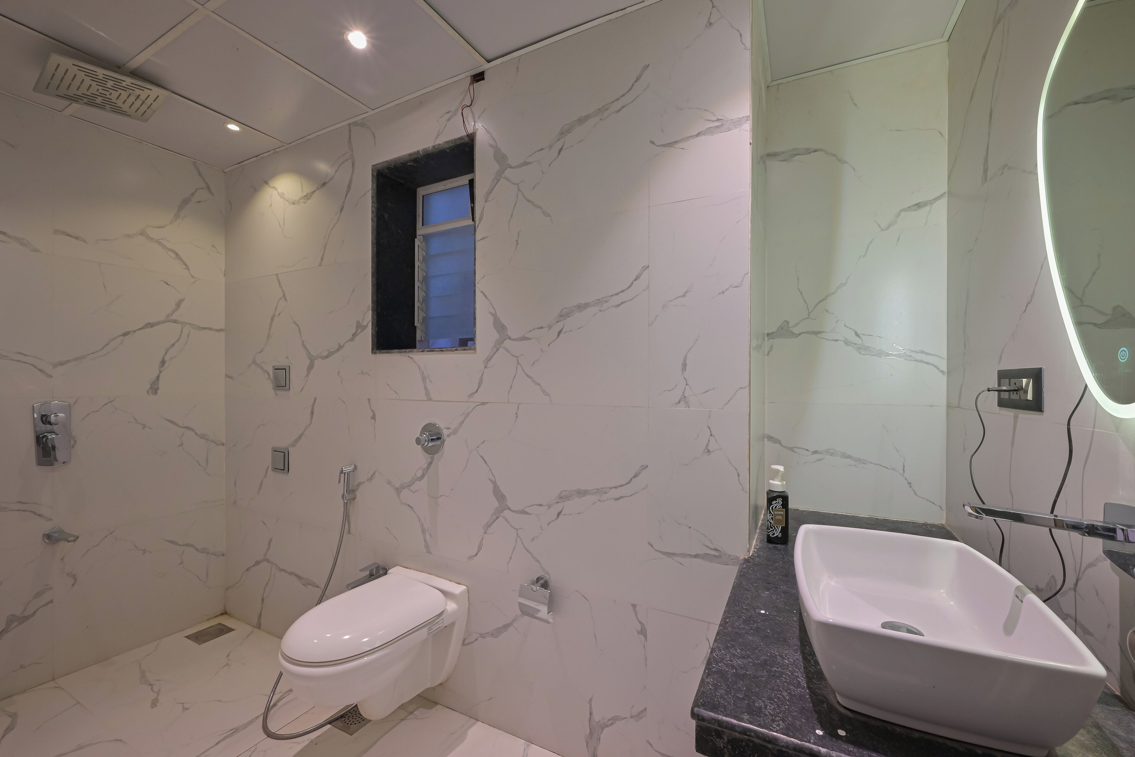 A bathroom with a toilet, sink, and shower.