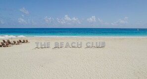 Relax on the beach at THE BEACH CLUB, where lounge chairs and umbrellas await.