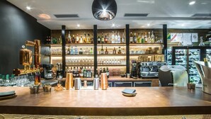 A bar area with shelves of liquor bottles, a coffee machine, and copper mugs. - Wifi, 200m from resort center, 1st floor, view mountain, sauna, balcony, parking, tv, 91m² (Courchevel)