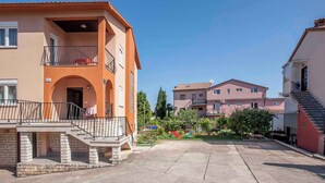 A residential building with a balcony, a staircase, and a small garden area with playground equipment. - Apartments in Rovinj/istrien 11491 (Rovinj)