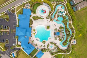 An aerial view of a resort with a central pool, multiple water slides, and a parking area. - Windsor Island Vacation Pool Home (Davenport)