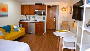 A compact living space with a kitchenette, a dining area, and a bed. - Steps from Waikiki Beach  Pool + Jacuzzi (Honolulu)