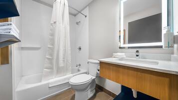A modern bathroom with a bathtub, toilet, and sink.