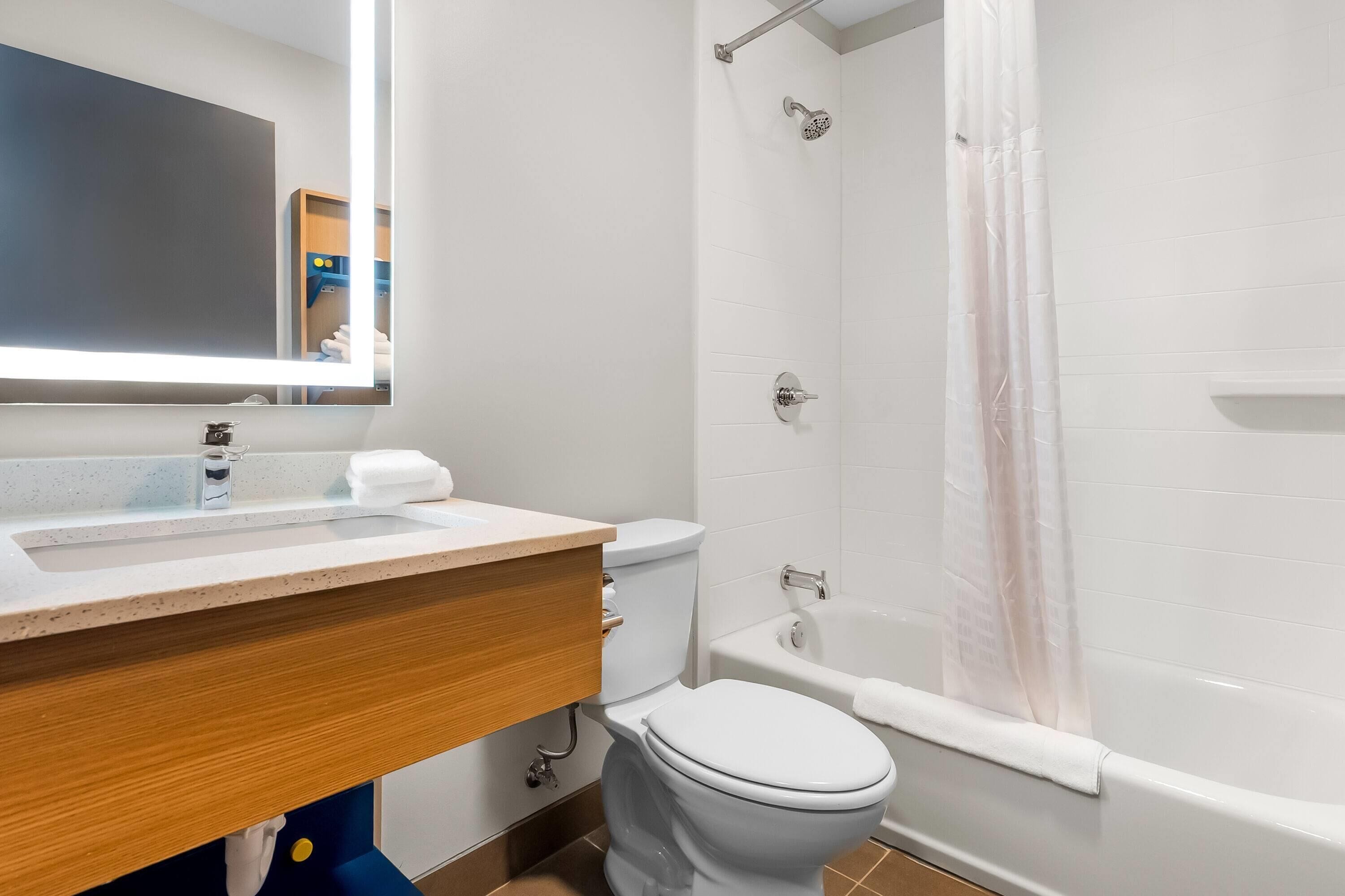 Ein modernes Badezimmer mit Waschbecken, Toilette und Badewanne.