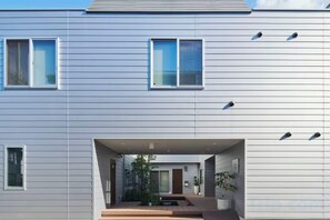 A modern building with a flat roof, large windows, and a covered entrance area. - Reikyo Garden Osaka (Osaka)