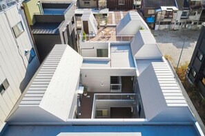 A multi-level residential building with a rooftop terrace and a small courtyard. - Reikyo Garden Osaka (Osaka)