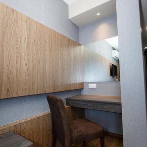 A modern room with a wooden accent wall, a built-in desk, and a chair. - Lintas Platinum Hotel (Kota Kinabalu)