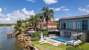 A waterfront property with a swimming pool, outdoor seating, and a view of the water. - VILLA JOYUDA (Cabo Rojo)