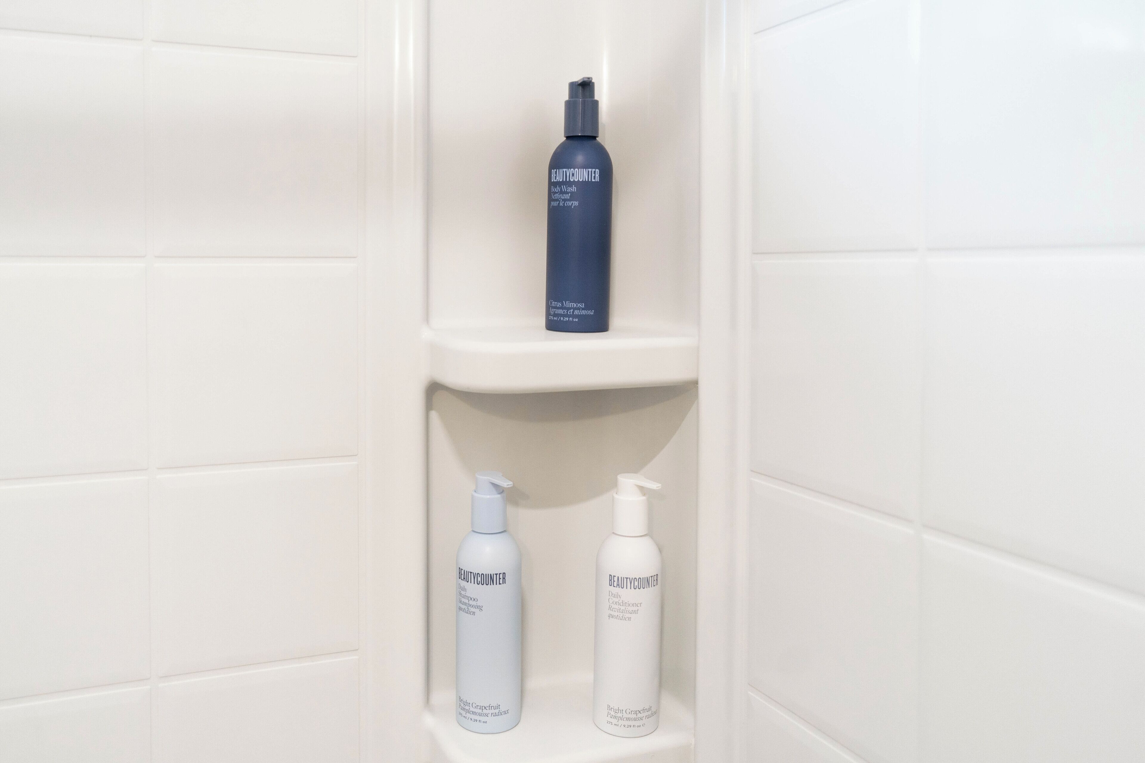 A bathroom shelf with three bottles of BeautyCounter products.
