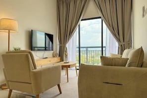 A modern living room with a sofa, armchairs, a TV, and a balcony view. - The Horizon Ipoh By Iconique Espace (Ipoh)