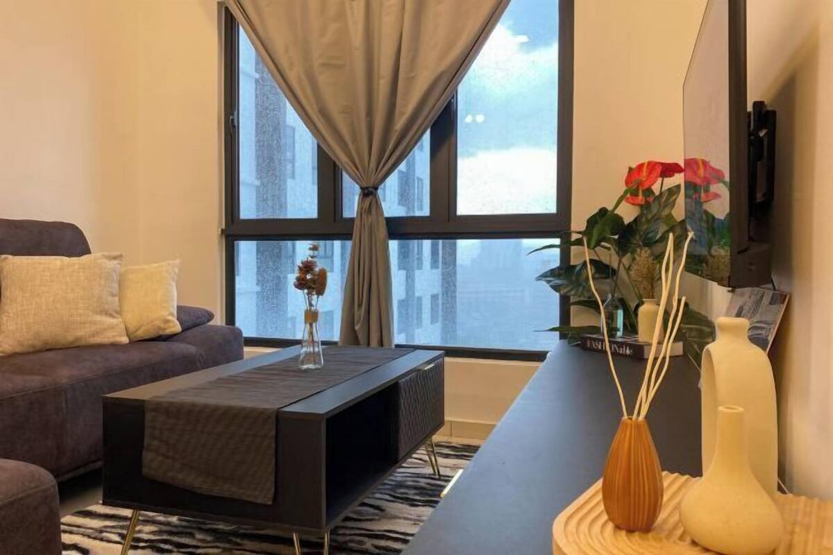 A modern living room with a sofa, coffee table, and decorative vases.