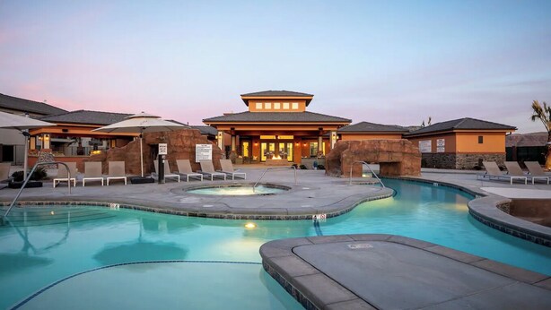 A hotel with a pool area, lounge chairs, and a building with a unique architectural design. - Zion's Premier Getaway for the entire family!  (Hurricane)