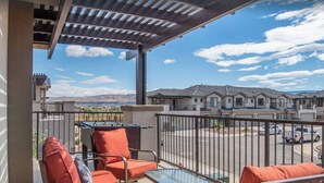 A balcony with outdoor seating and a view of residential buildings. - Zion's Premier Getaway for the entire family!  (Hurricane)