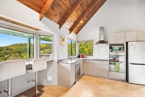Fridge, microwave, toaster, cookware/dishes/utensils - Opahi TreeHouse - Mahurangi West Holiday Home (Warkworth)