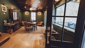 A cozy dining area with a wooden table, chairs, and a cabinet.