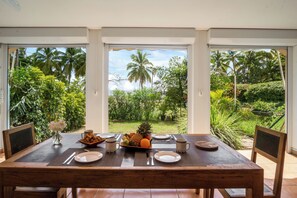 Enjoy a meal amidst lush gardens and tropical plants.