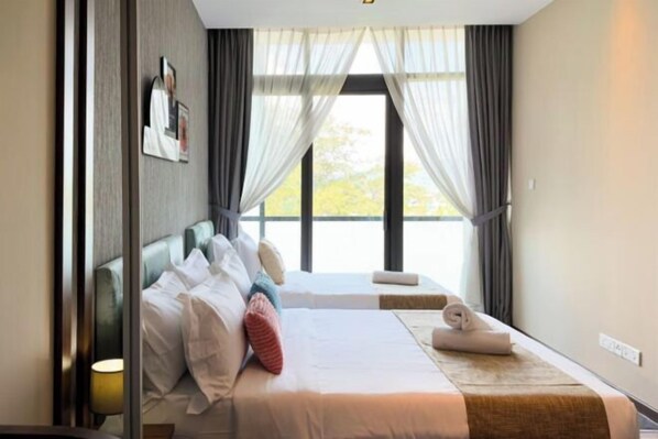 A hotel room with a bed, a bedside table, a lamp, and a window with curtains. - Homesuite' Home at Riverson Soho (Kota Kinabalu)
