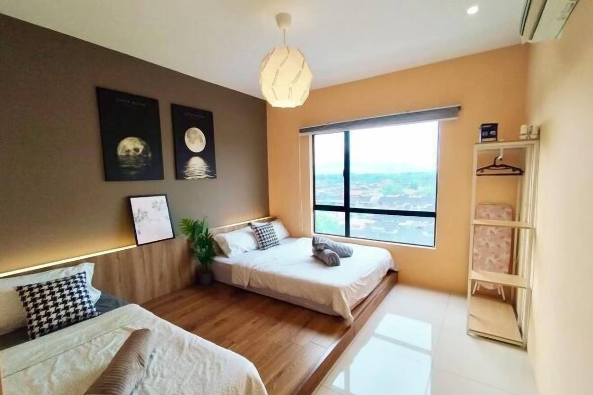 A modern bedroom with two beds, a large window, and a wall-mounted shelf.