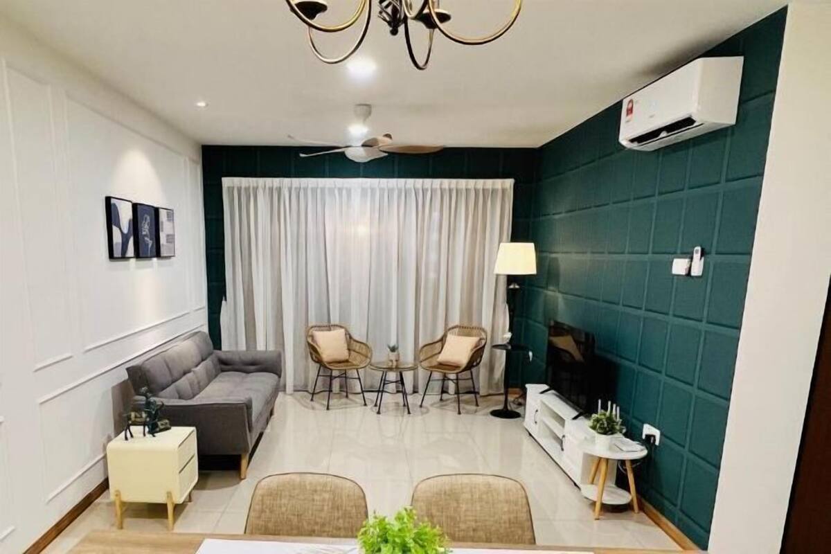 A modern living room with a sofa, two armchairs, a dining table, and a ceiling fan.