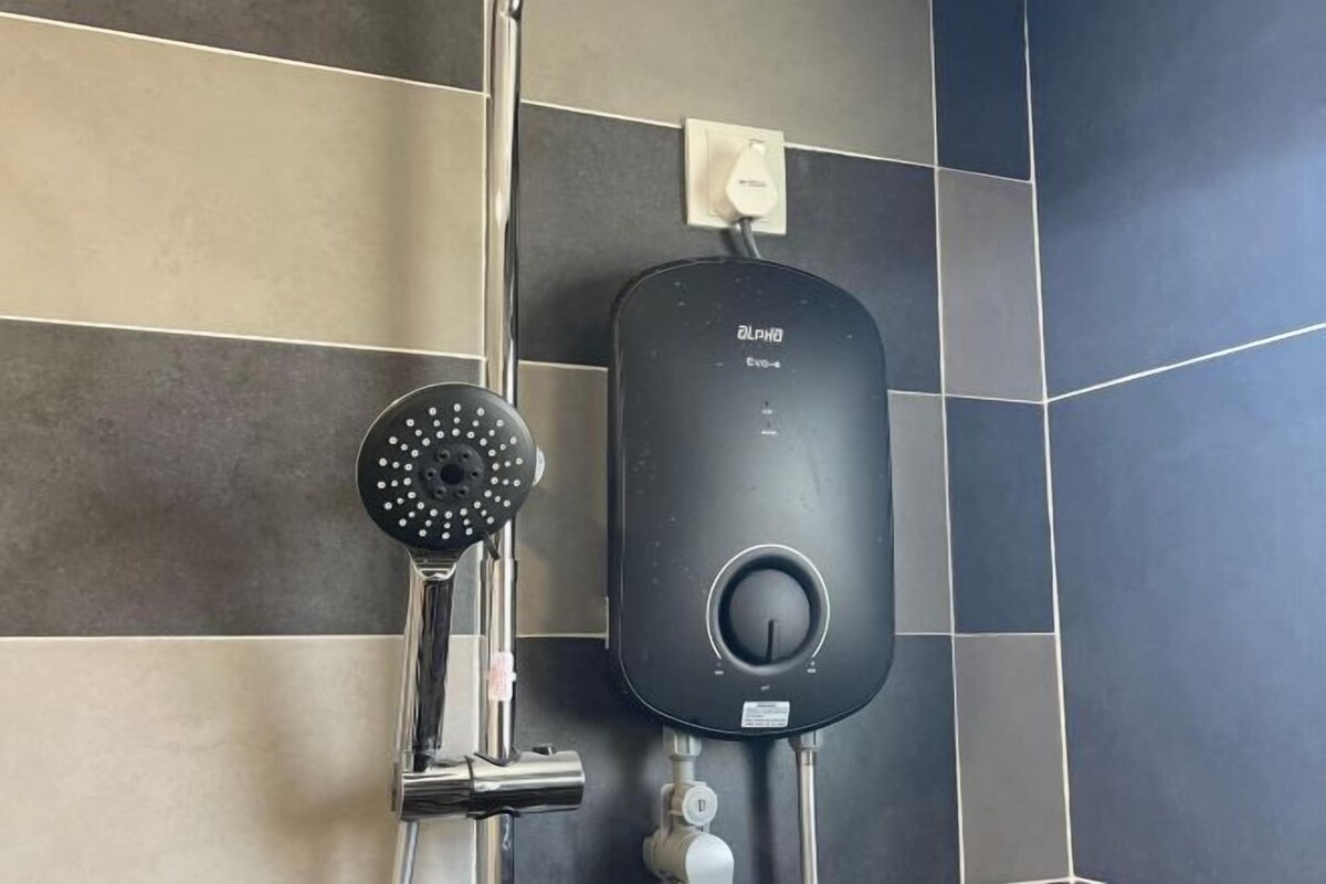 A modern bathroom with a wall-mounted shower and a control panel.