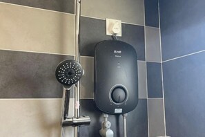 A modern bathroom with a wall-mounted shower and a control panel. - Ipoh The Manhattan Suites Apartment by IWH (Ipoh)