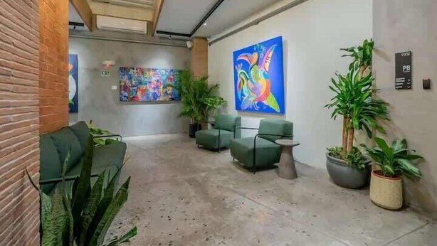 A lobby with seating, artwork, and potted plants. - Jr. Apartment Upper Level in Casco View (Panamá)