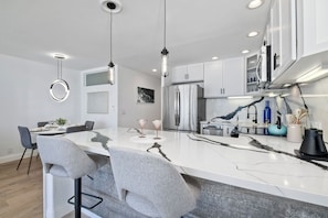 Sip morning coffee or grab a bite at the kitchen counter, offering seating for 2 - Solana Sunset – Stunning Beachside Retreat for 4! (Solana Beach)