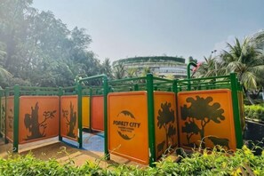 A series of green and orange barriers with tree and animal silhouettes, labeled 'Forest City.' - Gelang Patah Forest City-Ataraxia Park 3 (Gelang Patah)