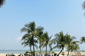 A beach with palm trees and a sign that reads 'LIME ODE OF THE YEAR'.
