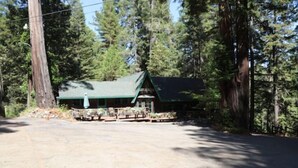A lodge with a green roof, surrounded by tall trees. - "The Lodge" River Access 2 Kitchens Dines 18 ppl

 (Garberville)