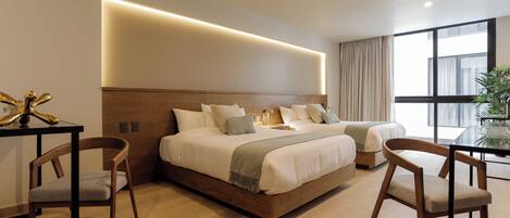 A modern hotel room with a large bed, two bedside tables, a desk, and a chair.
