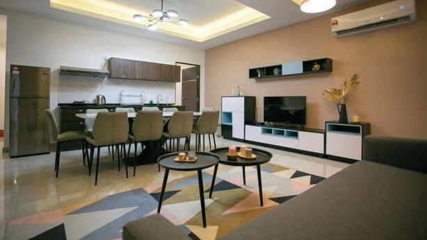 A modern living room with a dining area, a kitchen, and a TV. - Paradise Suite at KK Times Square, Beside Imago (Kota Kinabalu)
