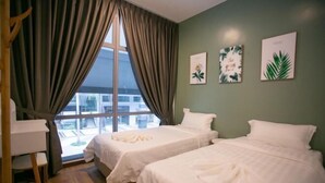 A hotel room with two beds, a desk, and a view of the city. - Paradise Suite at KK Times Square, Beside Imago (Kota Kinabalu)