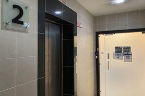 An elevator with a sign indicating it is the second floor. - Paradise Suite at KK Times Square, Beside Imago (Kota Kinabalu)