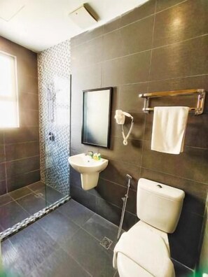 A modern bathroom with a shower, sink, and toilet. - Capital Express (Kota Kinabalu)