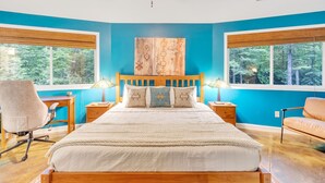 A bedroom with a large bed, two bedside tables, a desk, a chair, and a ceiling fan. - Secluded Yurt Hideaway 10 min to Table Rock (cleveland)