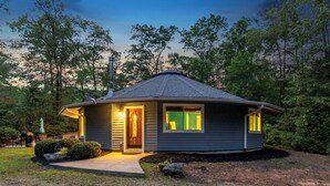 A single-story house with a gabled roof, a front door, and a small porch area. - Secluded Yurt Hideaway 10 min to Table Rock (cleveland)