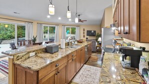A spacious kitchen with granite countertops, wooden cabinets, and modern appliances. - Secluded Yurt Hideaway 10 min to Table Rock (cleveland)