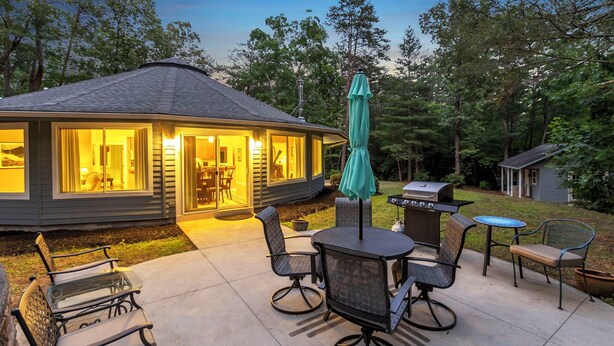 A house with a covered patio area featuring outdoor furniture and a grill. - Secluded Yurt Hideaway 10 min to Table Rock (cleveland)