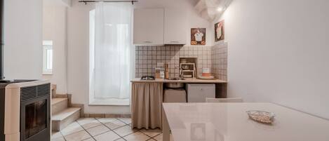 Fridge, stovetop, high chair, cookware/dishes/utensils