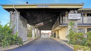 A covered walkway leading to Brookville Inn with a 10ft 0in clearance sign. - Brookville Inn By OYO Near Dayton International Airport (Brookville)