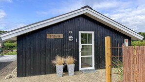 A black wooden building with a white door, a sign reading 'Viben', and a number '24' above the door. - Stunning home in Hemmet with sauna (Hemmet)