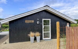 A black wooden building with a white door, a sign reading 'Viben', and a number '24' above the door. - Stunning home in Hemmet with sauna (Hemmet)