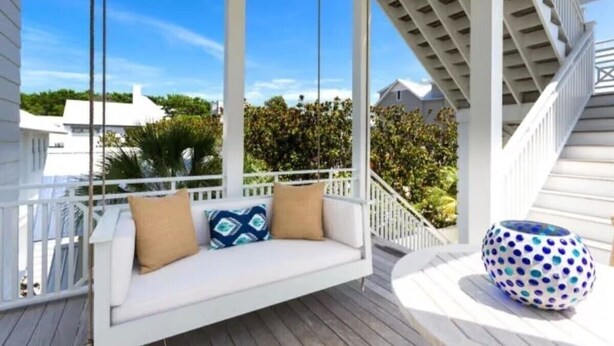 A white porch with a swing seat and a decorative bowl. - Luxury in Old Seagrove  • Heated Pool  • Walk to Beach • Elevator • Widows Peak (Santa Rosa Beach)