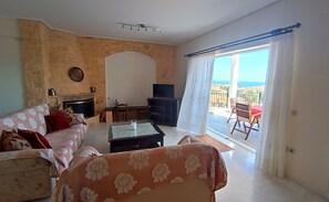 TV, fireplace - Cozy and luxury by the sea with spectacular view. Family sized with bbq and yard (Q349+FH Kalyvia Thorikou, Greece)