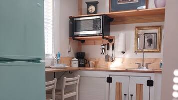 Fridge, microwave, coffee/tea maker, cookware/dishes/utensils