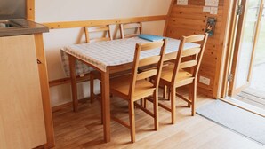 A small kitchen with wooden furniture, a table, and chairs.